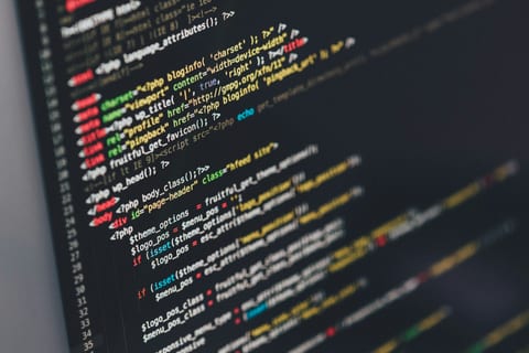 Developer writing custom driver code on a laptop