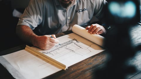 Architects reviewing AV system blueprints