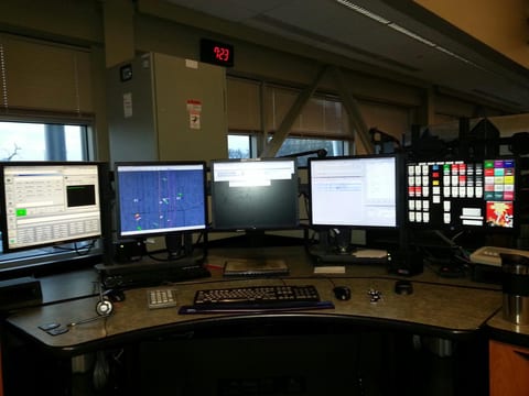 911 dispatch console with multiple monitors and a keyboard